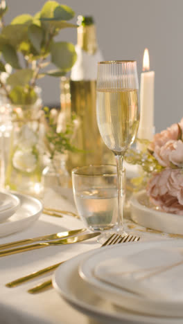 Vertical-Video-Of-Table-Set-For-Meal-At-Wedding-Reception-With-Filled-Glasses-Of-Champagne